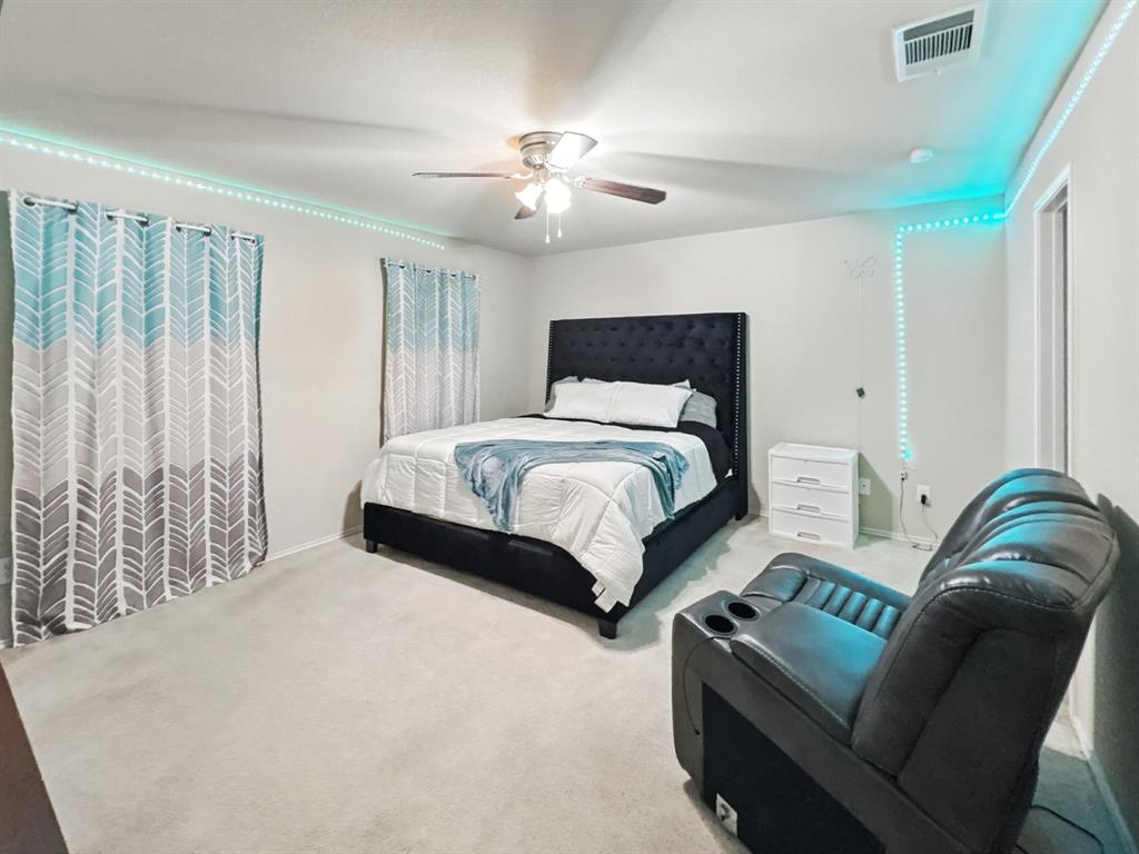 1330 White Tail Ridge Cedar Hill, TX 75104 - Photo 5 of 17 a bedroom with a bed and a chandelier