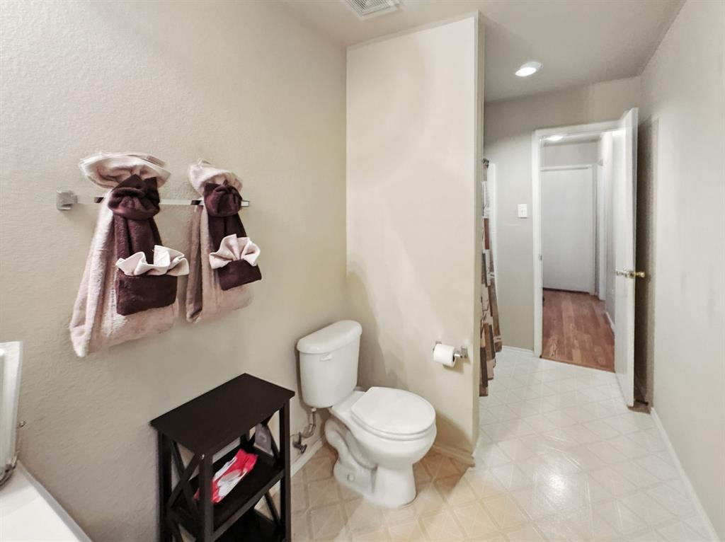 1330 White Tail Ridge Cedar Hill, TX 75104 - Photo 10 of 17 a bathroom with a toilet a sink and shower