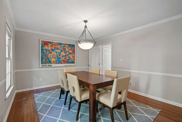 a view of a dining room with furniture wooden floor and a chandelier