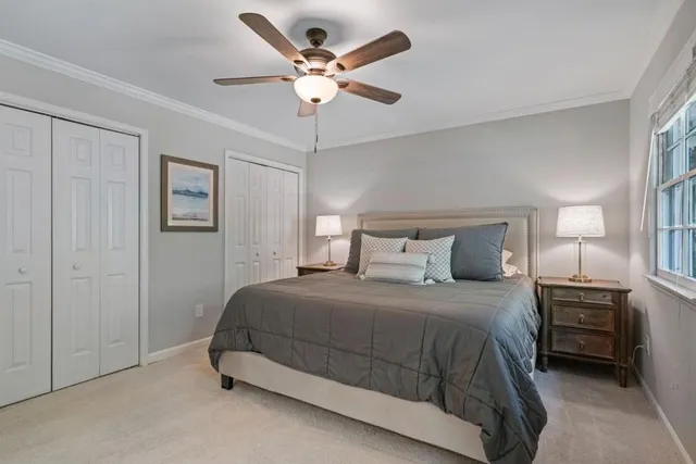 a bedroom with a bed and a ceiling fan