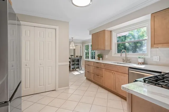 a kitchen with a sink cabinets and window