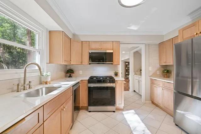 a kitchen with a sink stove and refrigerator