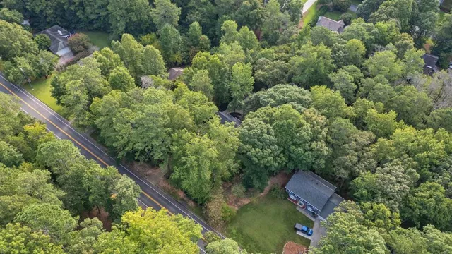an aerial view of town with trees and houses