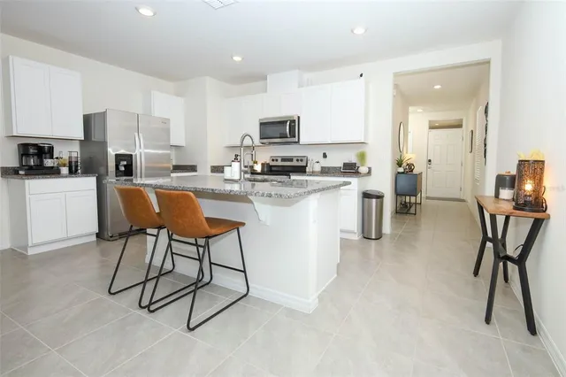 a kitchen with stainless steel appliances granite countertop a sink and cabinets