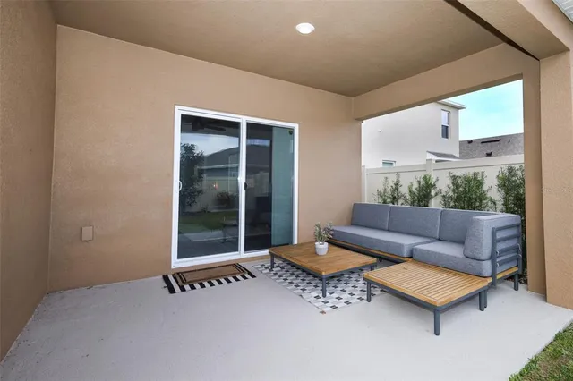 a view of a couches in the patio next to a yard