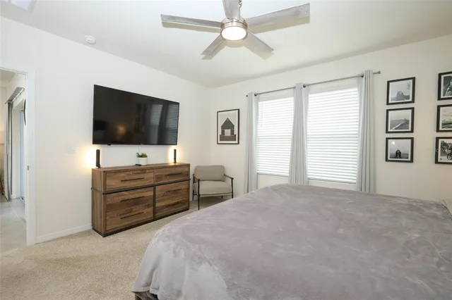 a bedroom with furniture and a flat screen tv