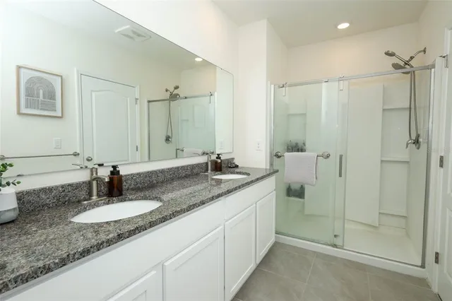 a bedroom with a bed and a computer on a table