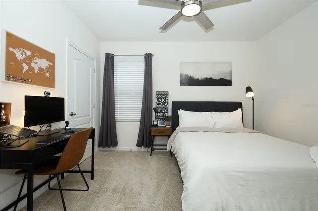 a bedroom with a bed and a chair in it