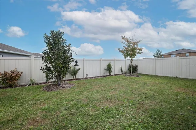 a view of house with backyard and garden