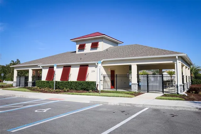 a view of swimming pool with lawn chairs potted plants