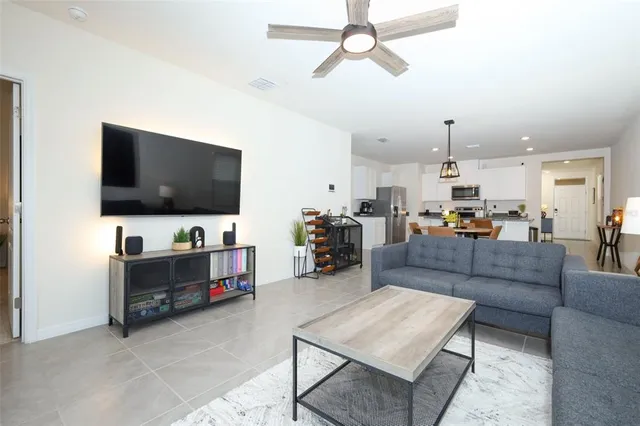 a living room with furniture and a clock