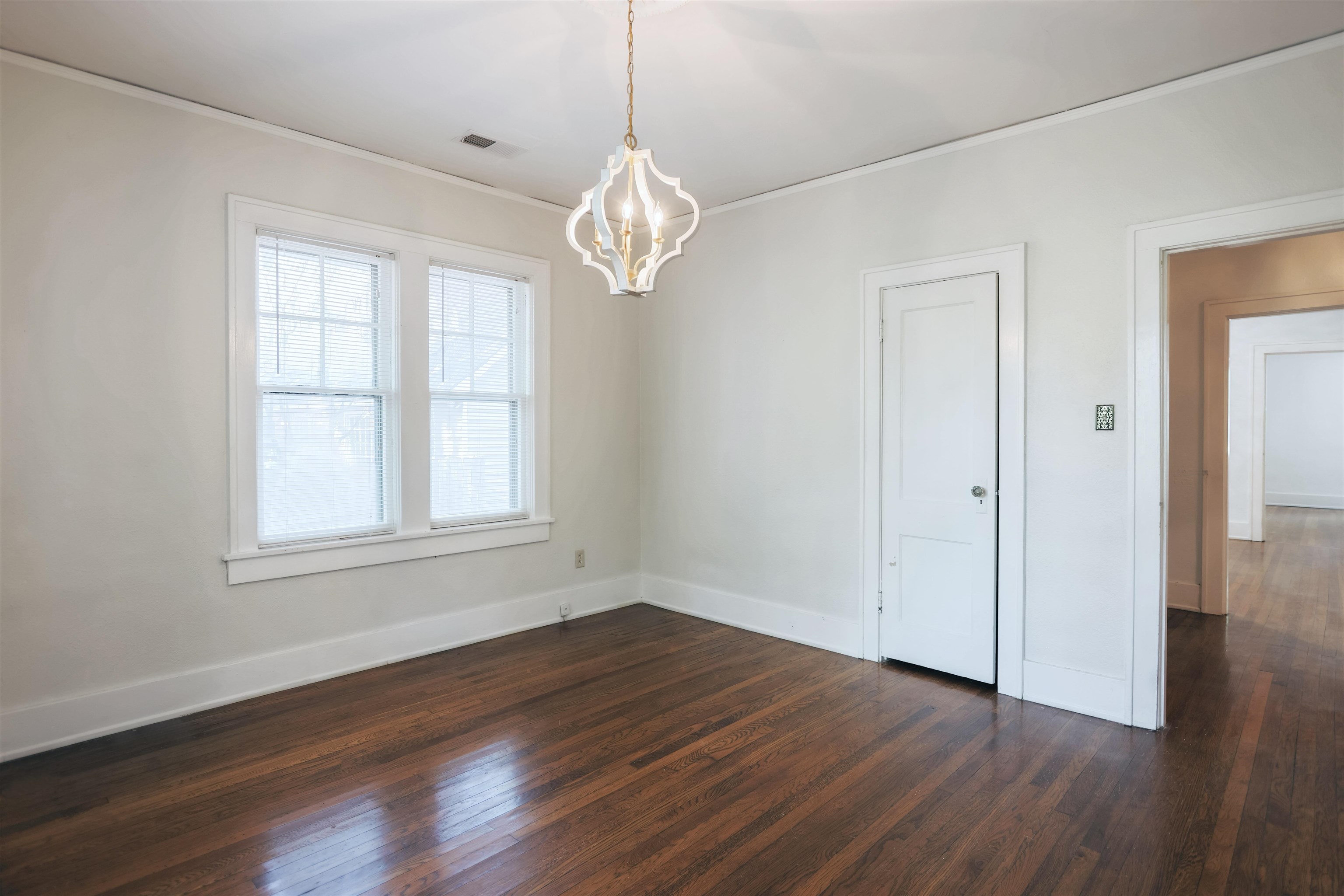 401 Alexander Street Memphis, TN 38111 - Photo 14 of 21 an empty room with wooden floor chandelier and windows