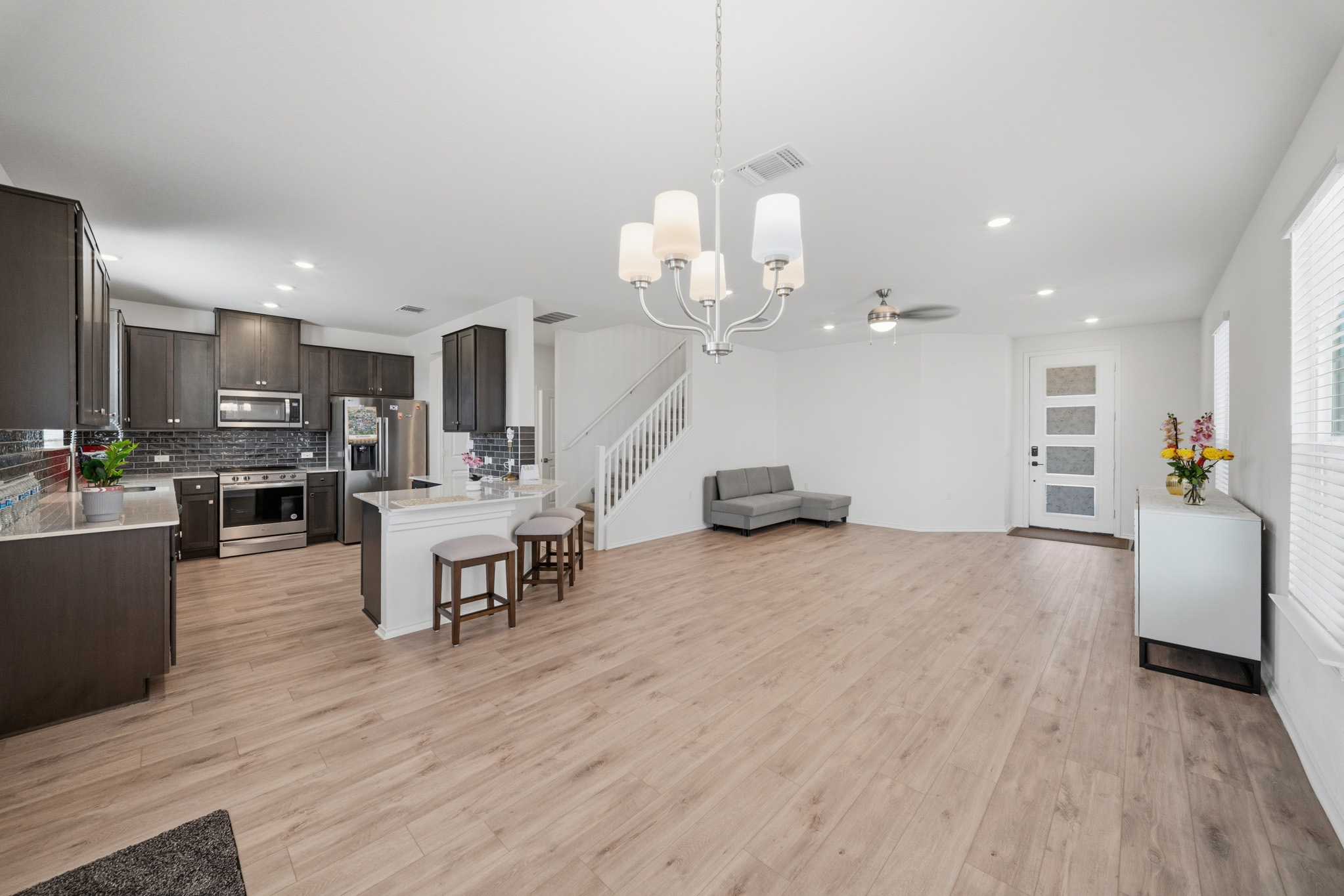 4616 Syndicate Rd Manor Manor, TX 78653 - Photo 6 of 15 An open-concept living space with a contemporary kitchen and durable flooring provides seamless flow for daily living.