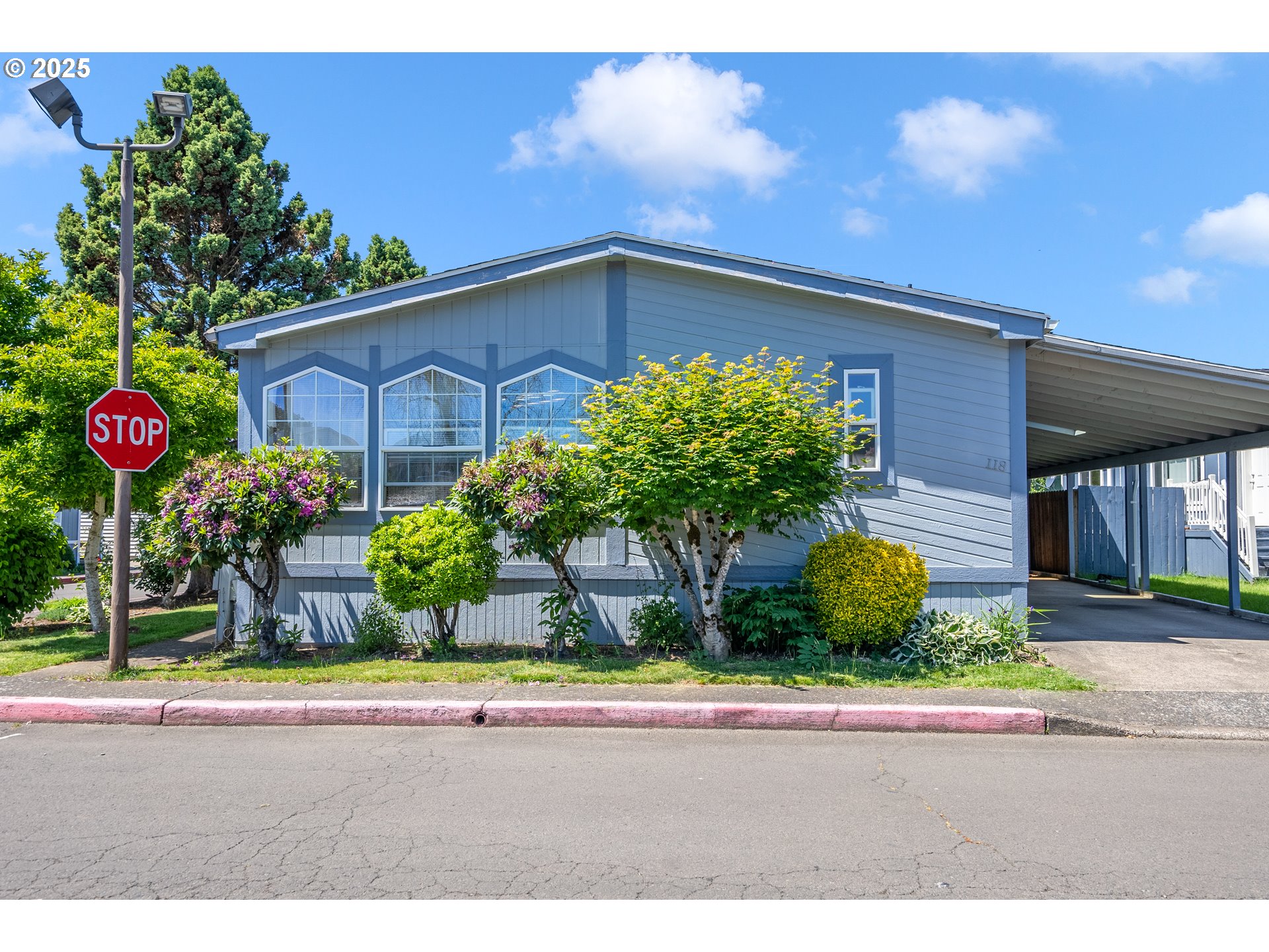 1949 Southeast Palmquist Road, Unit 118 Gresham, OR 97080 - Photo 1 of 32 a view of a house and a yard