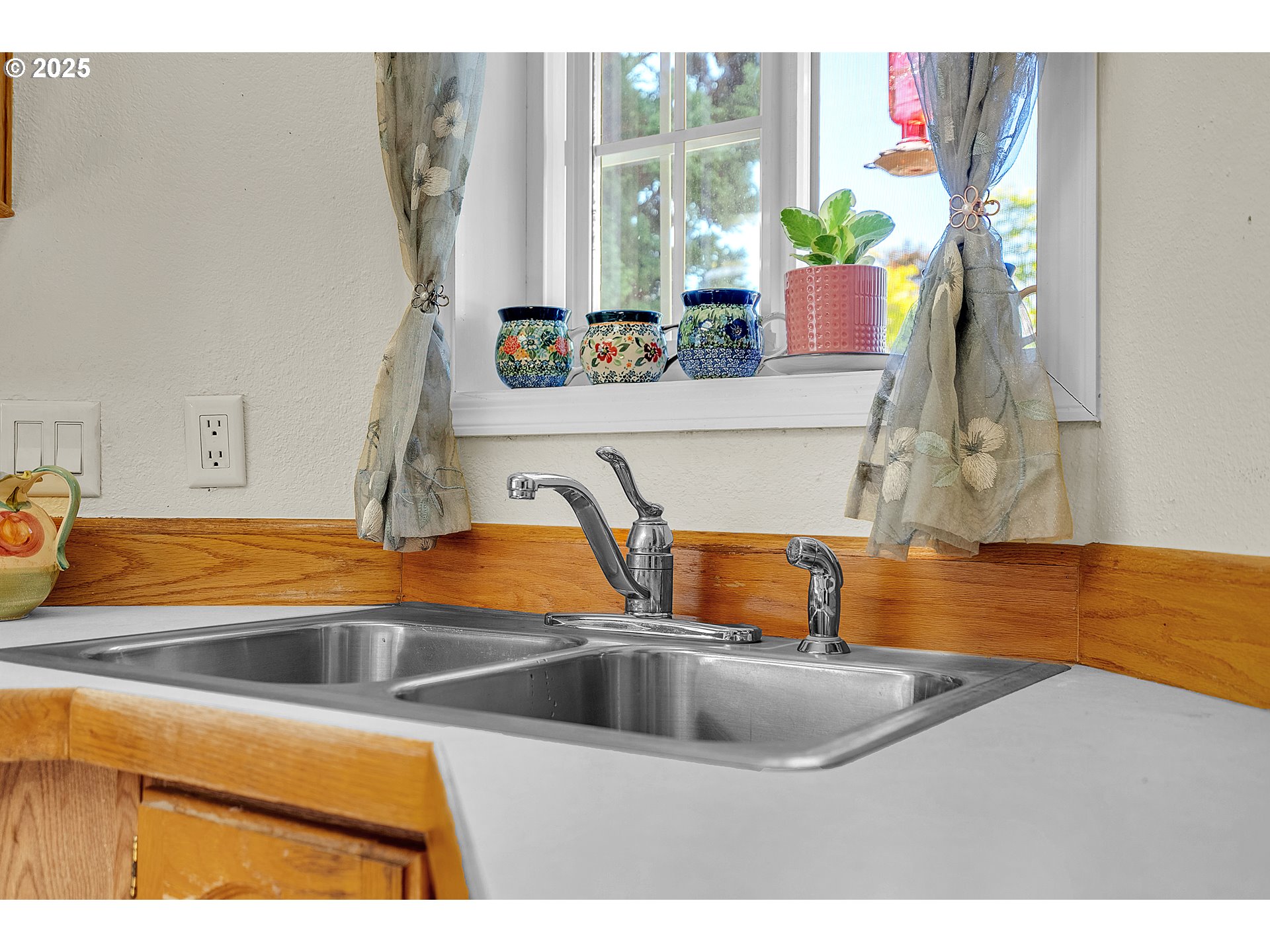 1949 Southeast Palmquist Road, Unit 118 Gresham, OR 97080 - Photo 14 of 32 a kitchen with a sink and a potted plant