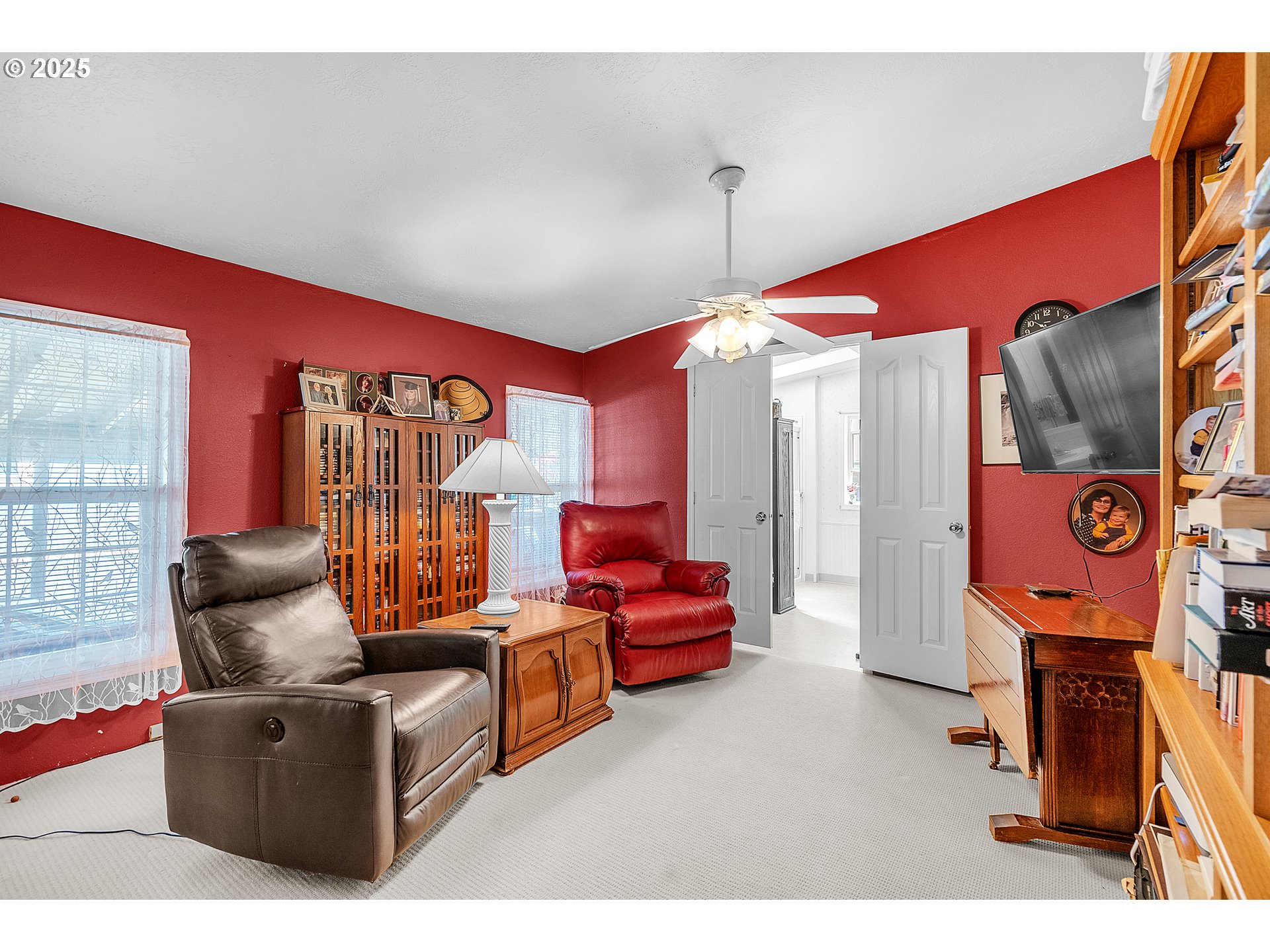 1949 Southeast Palmquist Road, Unit 118 Gresham, OR 97080 - Photo 17 of 32 a living room with furniture a ceiling fan and a window