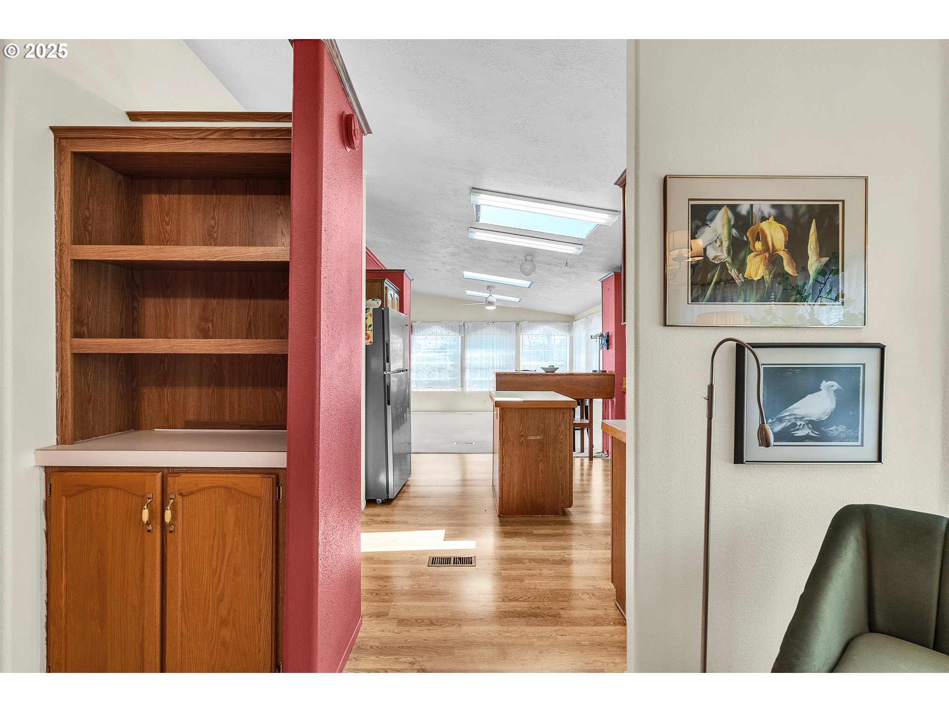 1949 Southeast Palmquist Road, Unit 118 Gresham, OR 97080 - Photo 10 of 32 a hallway with front door wooden floor and cabinet