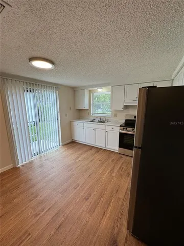 a kitchen with a refrigerator and a sink
