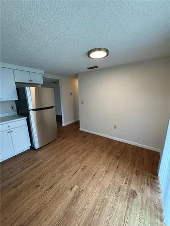 a view of a kitchen with a sink and a refrigerator
