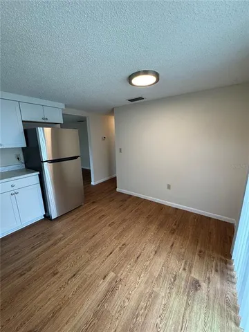 a view of a kitchen with a sink and a refrigerator