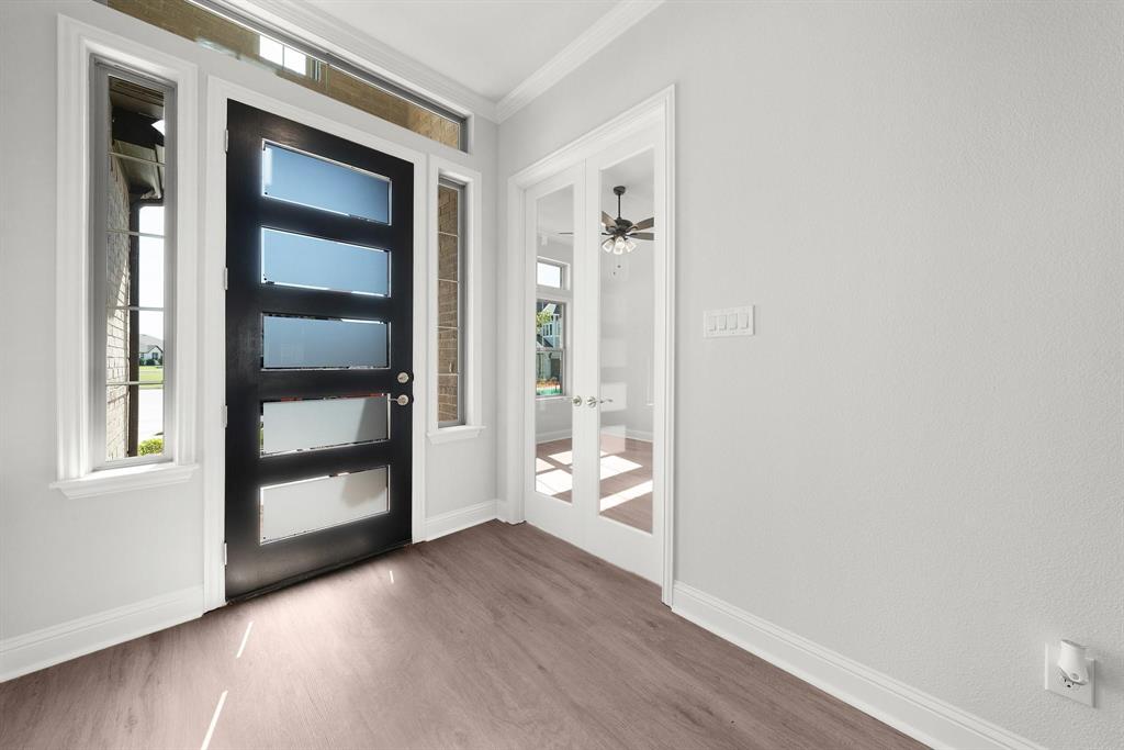 708 Proverbs Court Heath, TX 75032 - Photo 5 of 28 a view of a hallway with wooden floor and cabinet