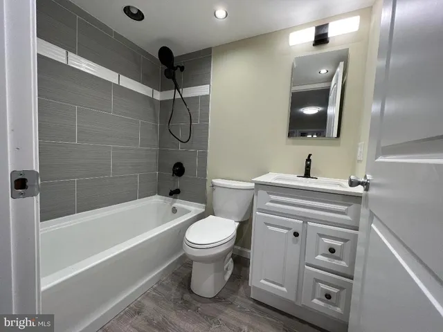 a bathroom with a sink a toilet and bathtub