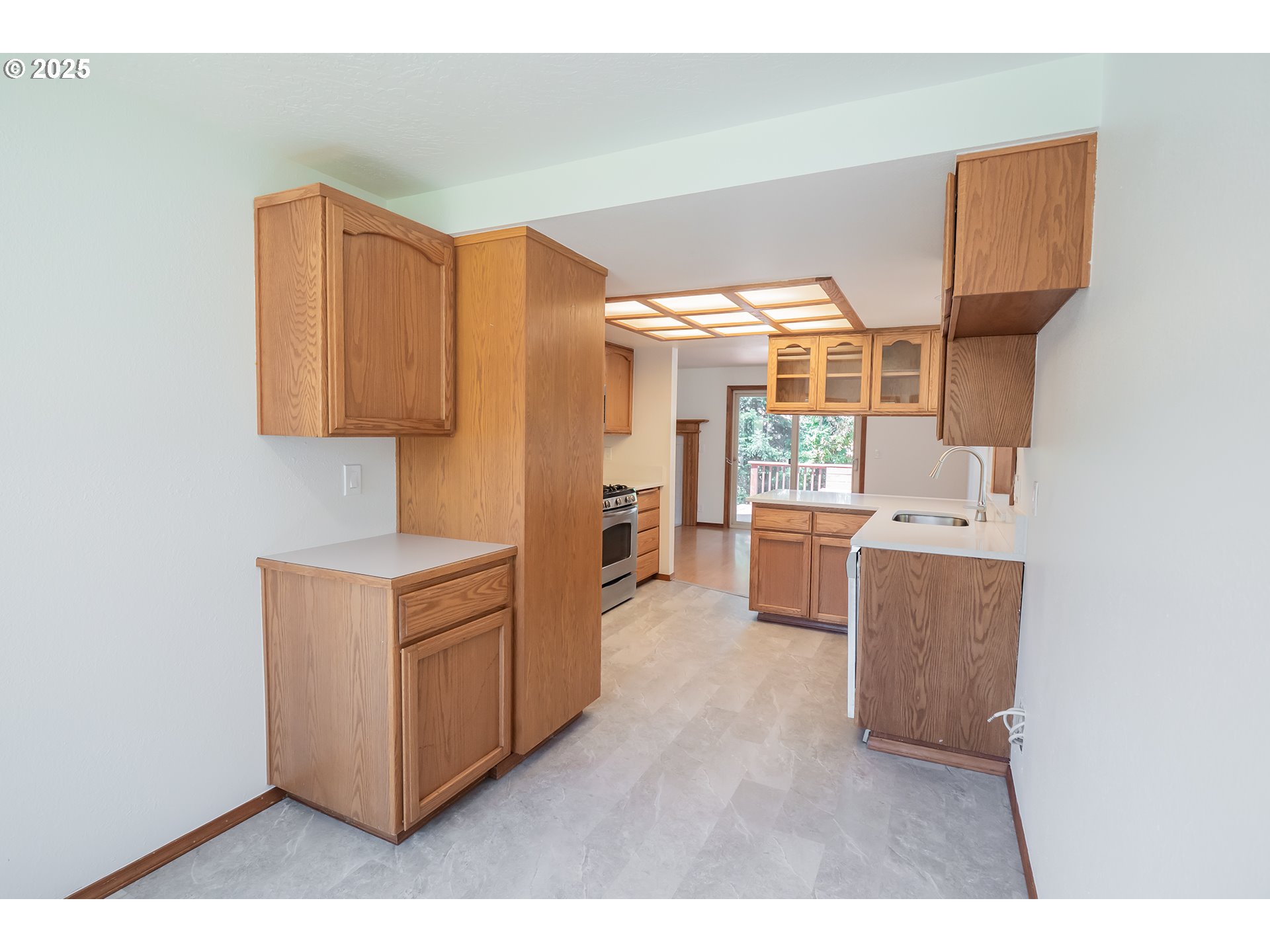 6894 C Street Springfield, OR 97478 - Photo 12 of 32 a kitchen with stainless steel appliances a stove and more cabinets