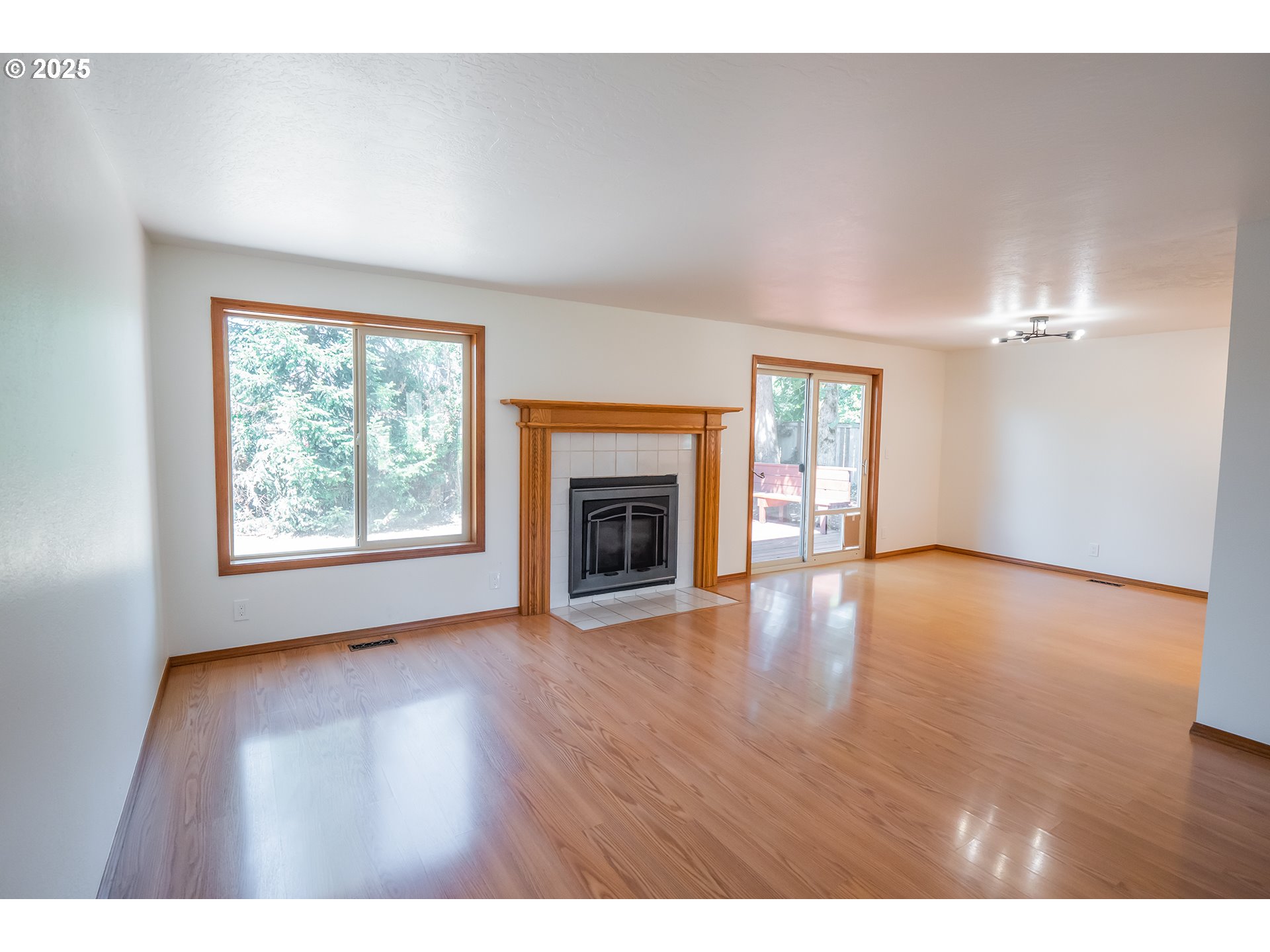 6894 C Street Springfield, OR 97478 - Photo 5 of 32 a view of an empty room with window and wooden floor