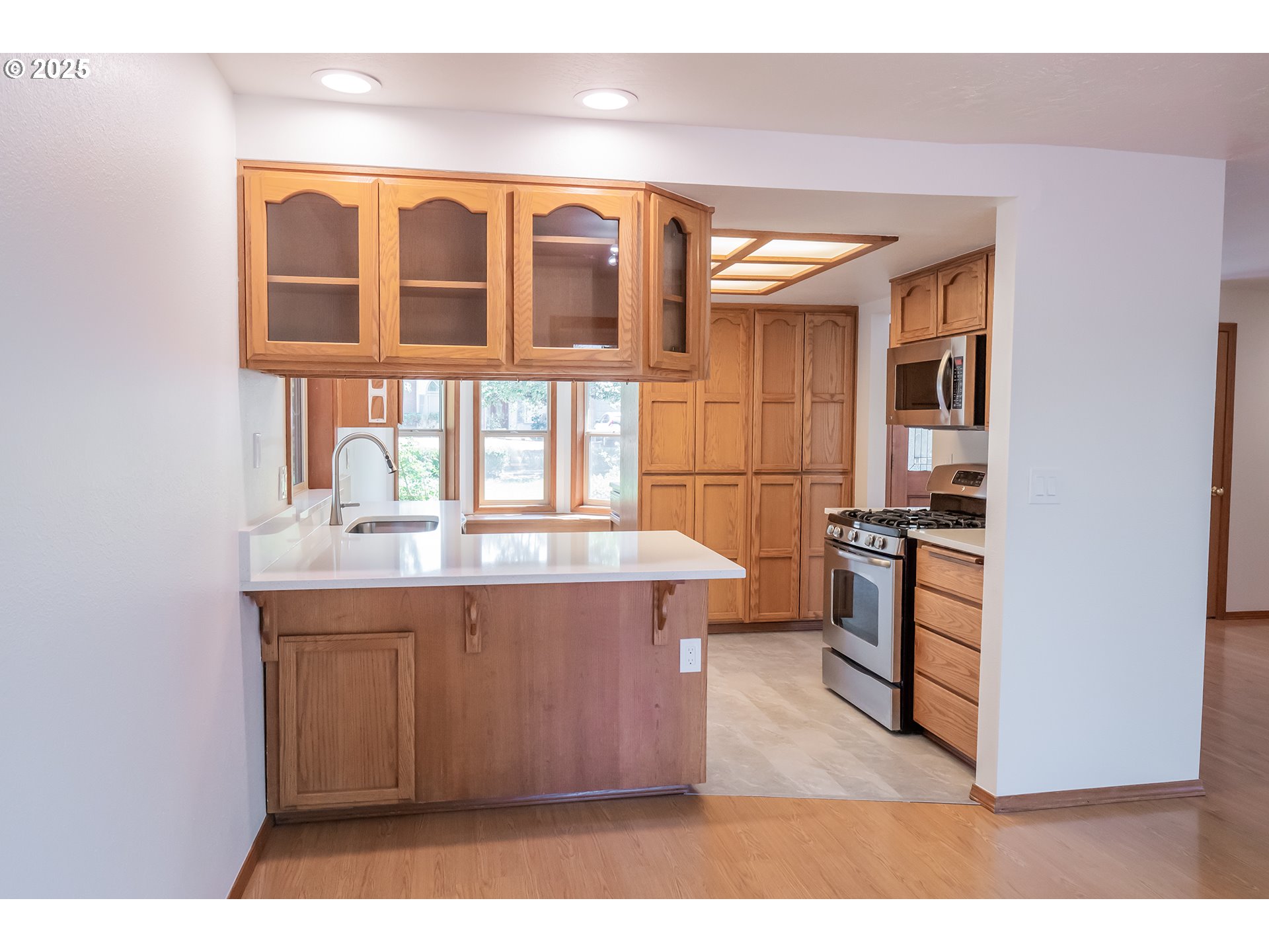 6894 C Street Springfield, OR 97478 - Photo 8 of 32 a view of kitchen with kitchen island wooden floor and stainless steel appliances