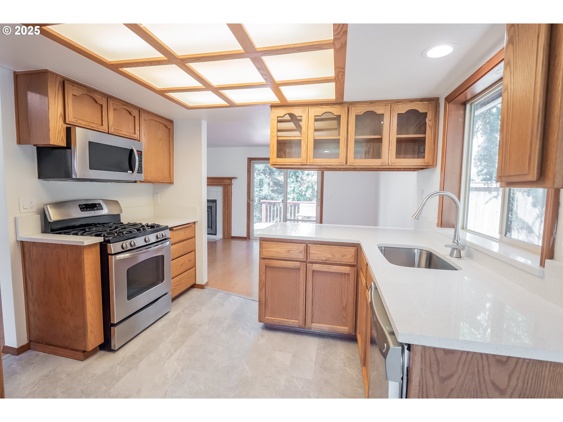 6894 C Street Springfield, OR 97478 - Photo 10 of 32 a kitchen with stainless steel appliances granite countertop a stove a sink and a microwave