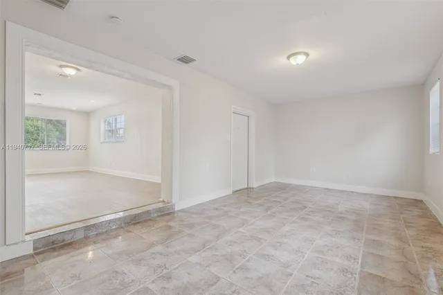 a view of an empty room and entryway