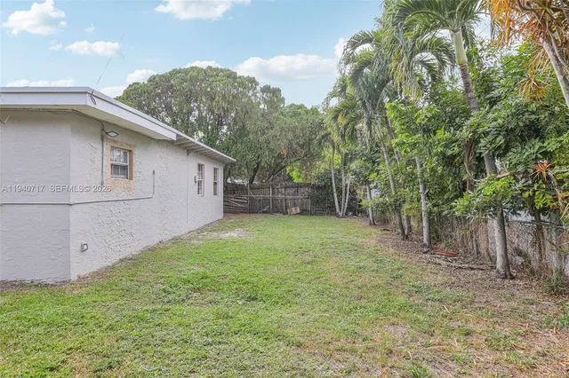 a front view of a house with a yard and a garage