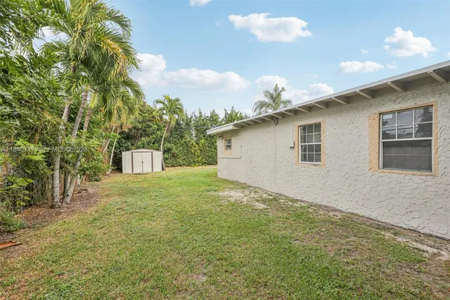 a view of a house with a swimming pool and a yard