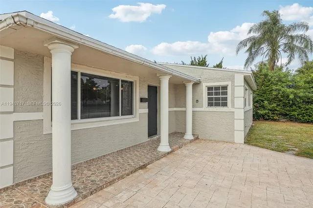 a picture of a bathroom with a white wall and a picture