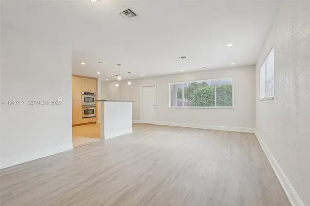 a kitchen with stainless steel appliances granite countertop a sink and a refrigerator