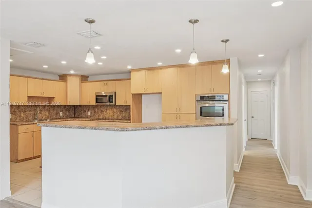 a kitchen with a sink and refrigerator