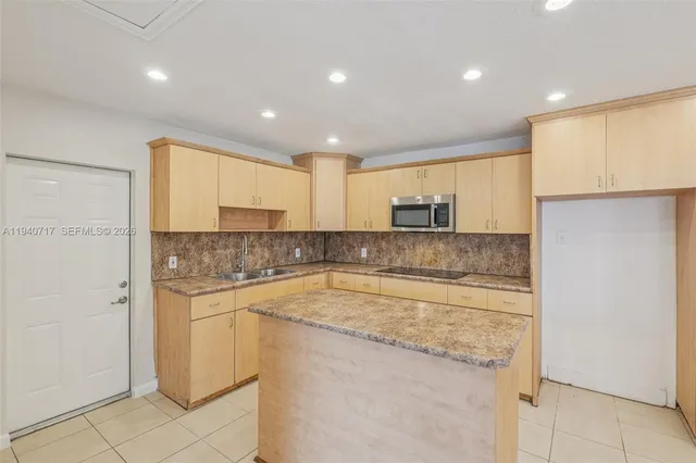 a kitchen with a sink stainless steel appliances and cabinets