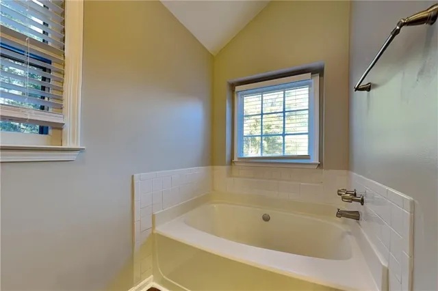 a white bath tub sitting next to a window
