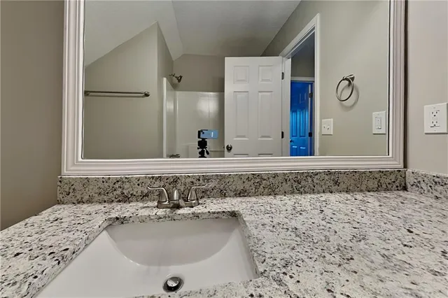 a bathroom with a sink and a mirror