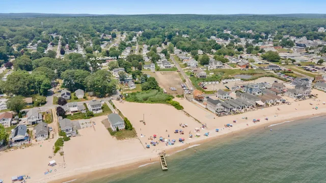 an aerial view of residential houses with outdoor space and trees