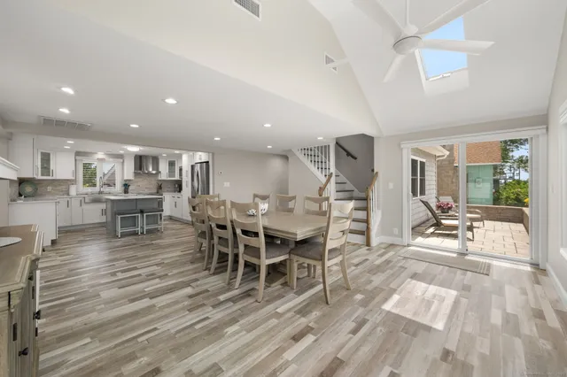 a living room with furniture a dining table and kitchen view