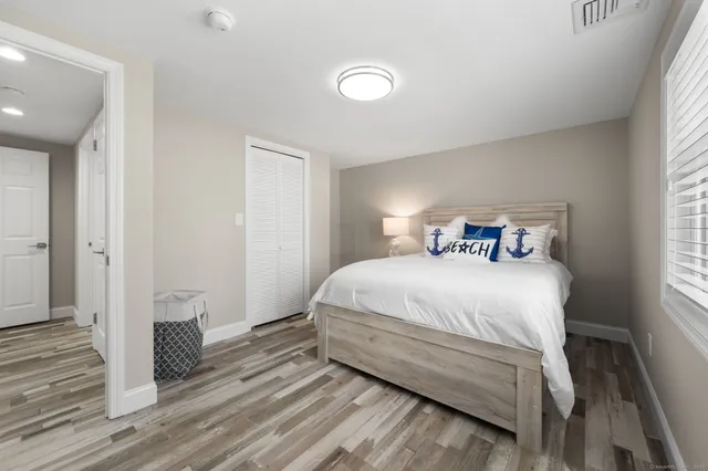 a bedroom with a bed and a closet