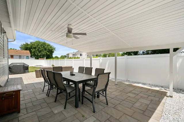 a view of a patio with table and chairs