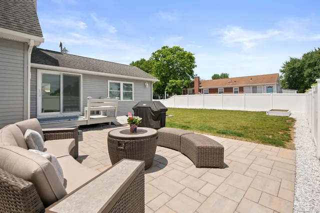 a view of a patio with couches and a fire pit
