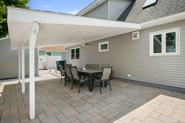a view of a patio with table and chairs and couches
