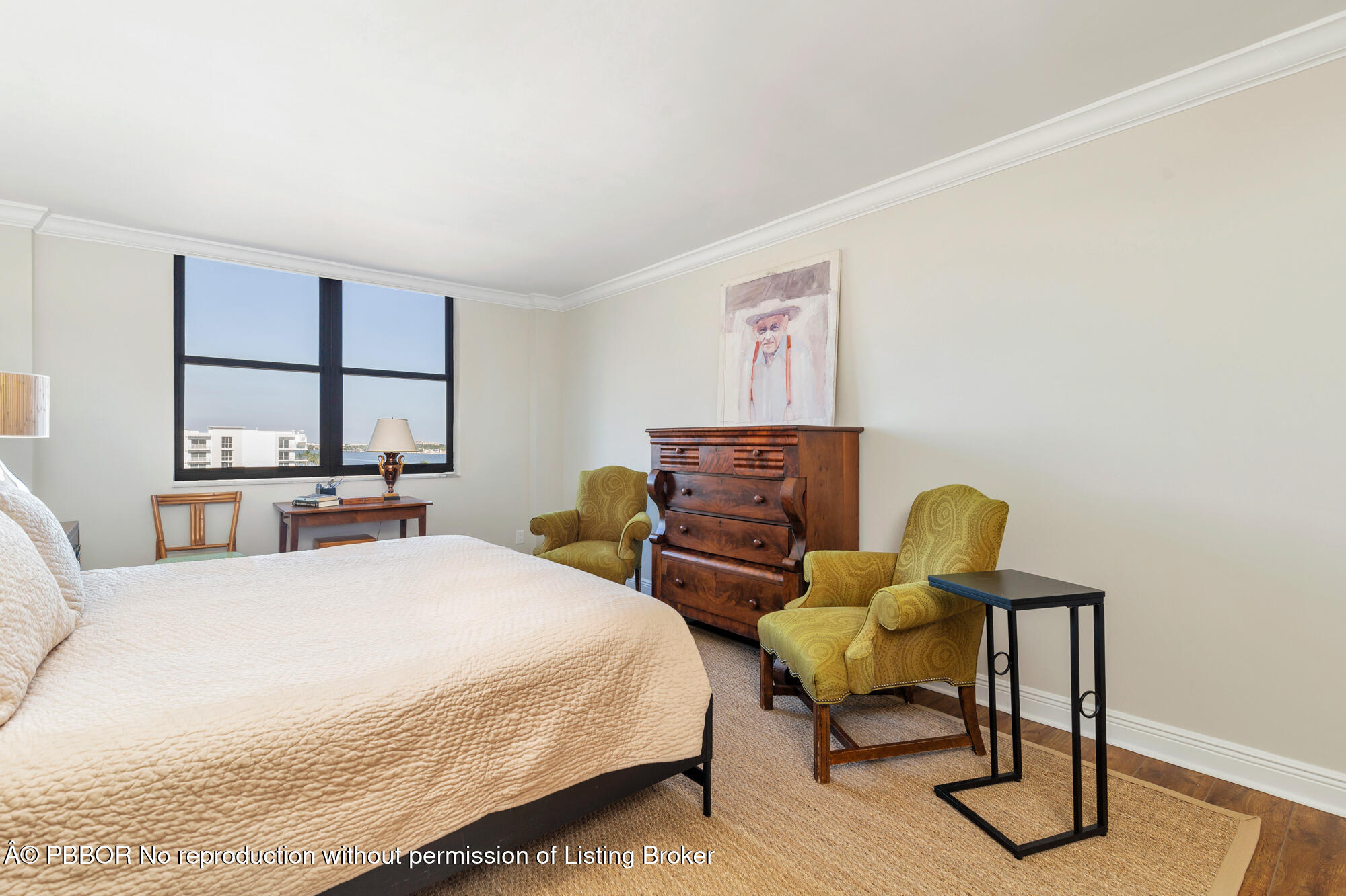 3800 Washington Road, Unit 808 West Palm Beach, FL 33405 - Photo 17 of 35 a bedroom with a bed a chair and painting on the wall