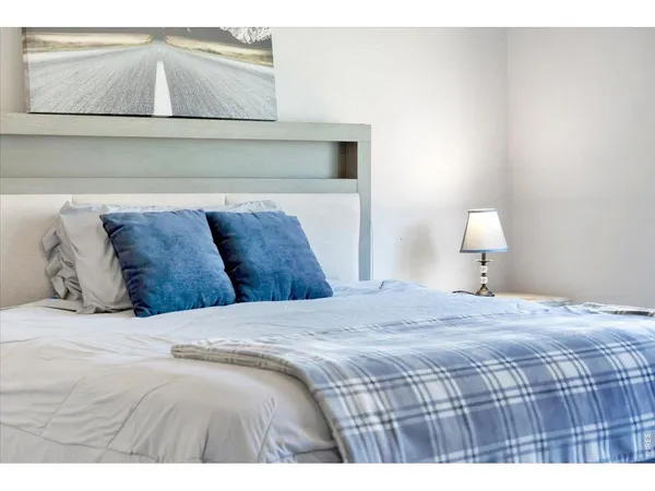 a bedroom with a bed and night stand