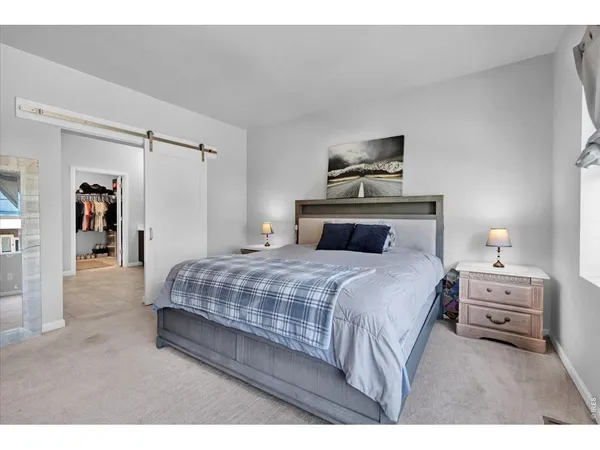 a bedroom with a bed and a night stand