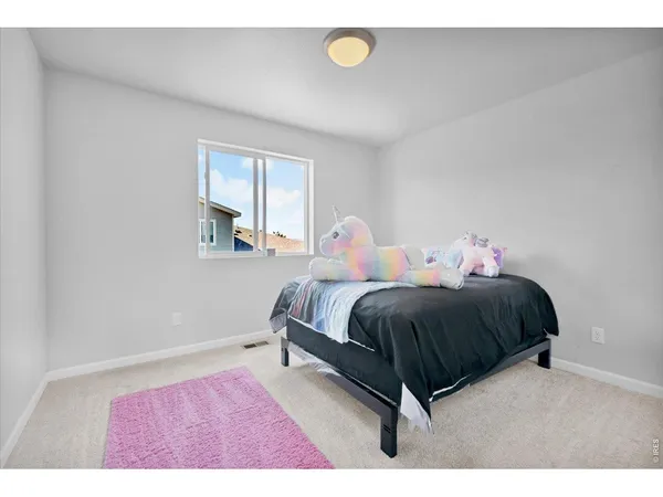 a spacious bedroom with a bed and window
