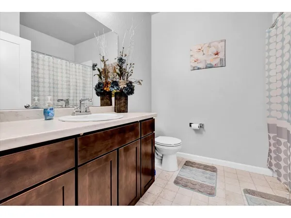 a bathroom with a sink mirror vanity and toilet